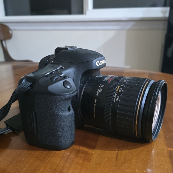 Canon EOS 7D camera body and Canon EF 28-135mm lens with strap